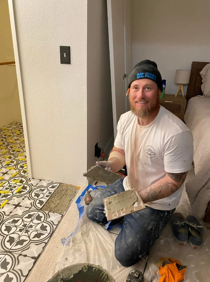 Kyle personally installing tile by hand